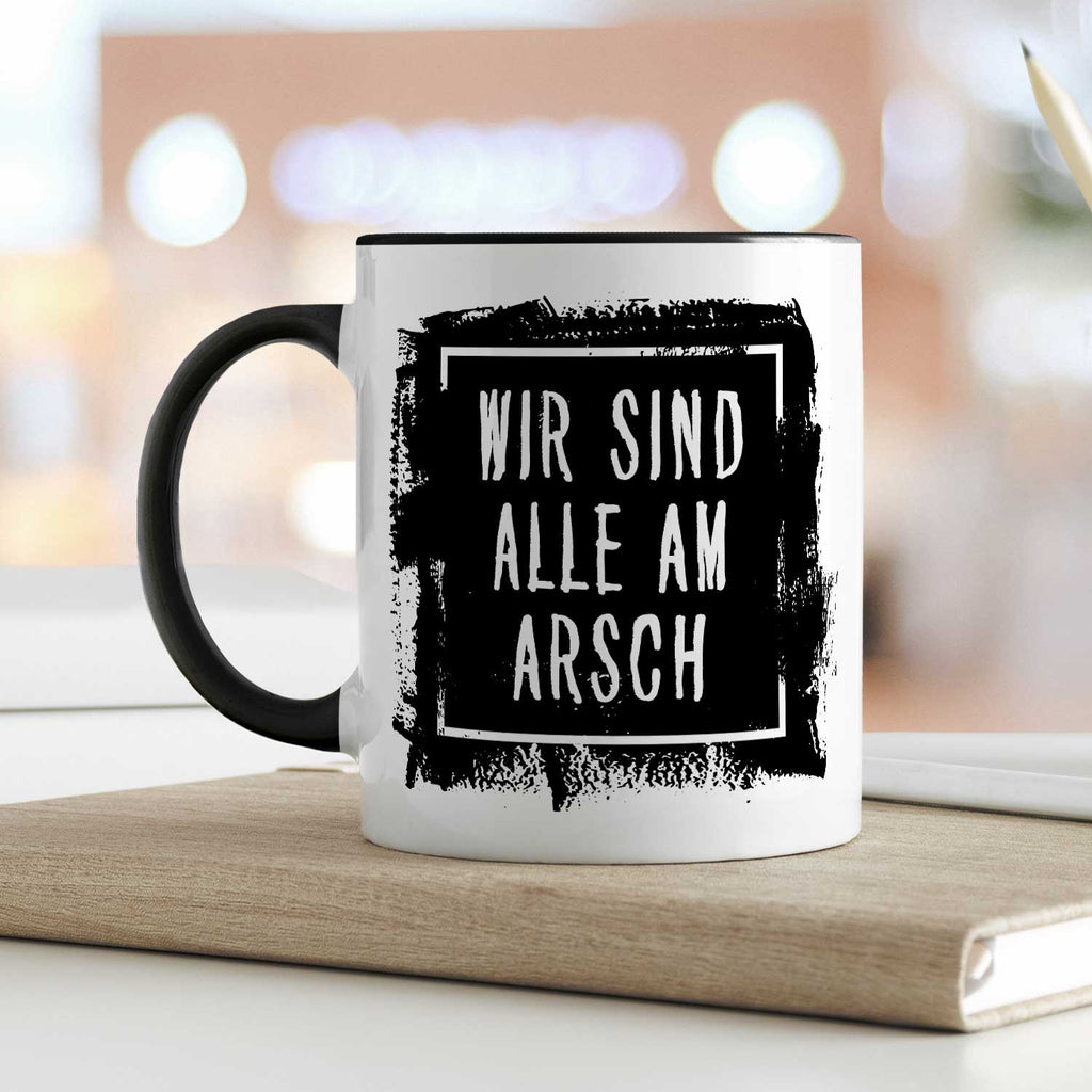 Bedruckte Tasse mit Spruch - "Wir sind alle am Arsch"